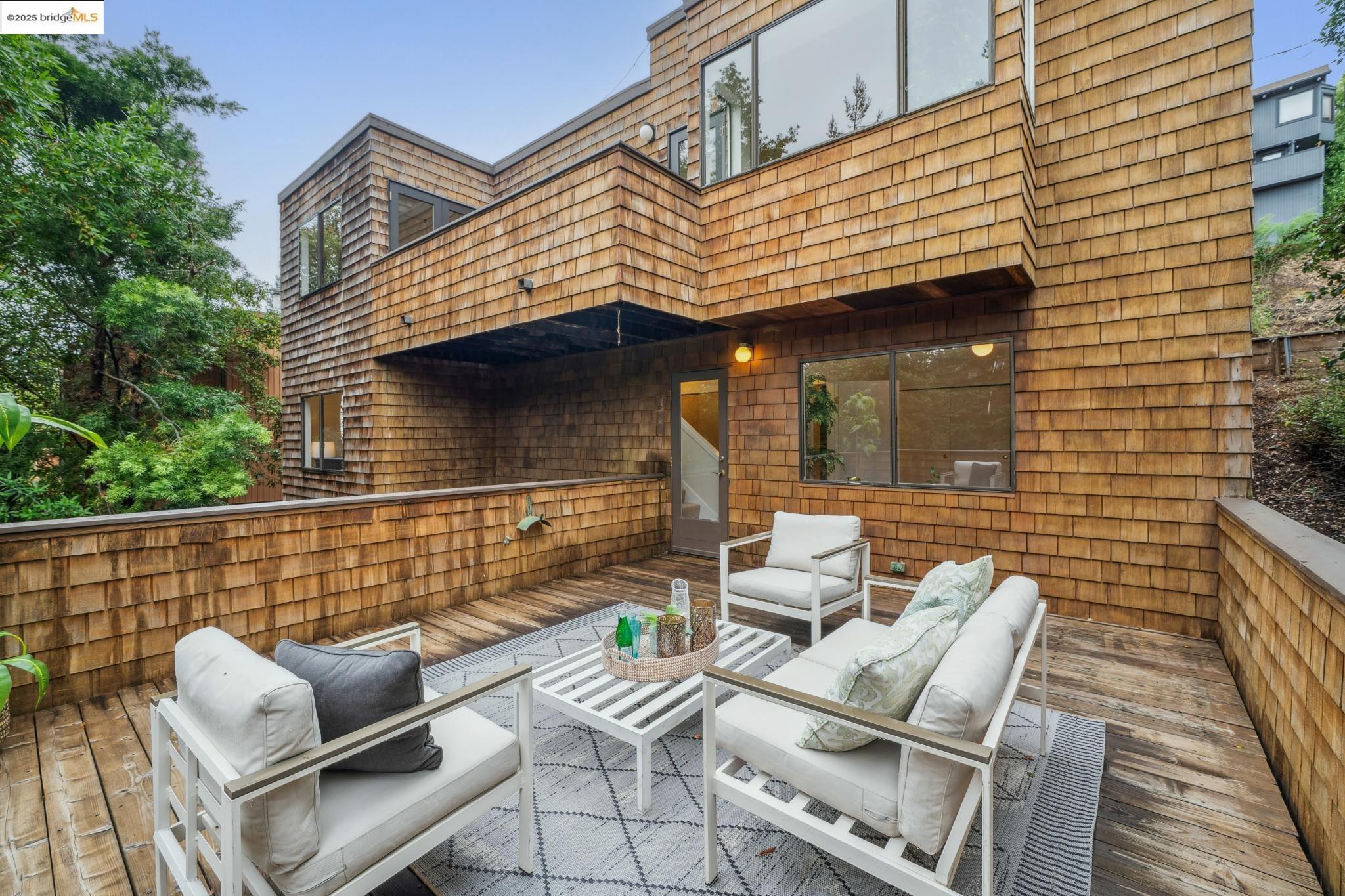 a view of patio with table and chairs and potted plants