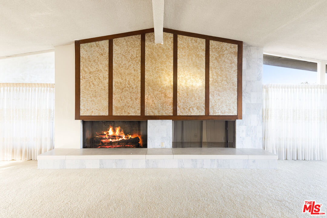1950 Carla Ridge Beverly Hills, CA 90210 - Photo 11 of 29 a view of an empty room with a floor to ceiling window