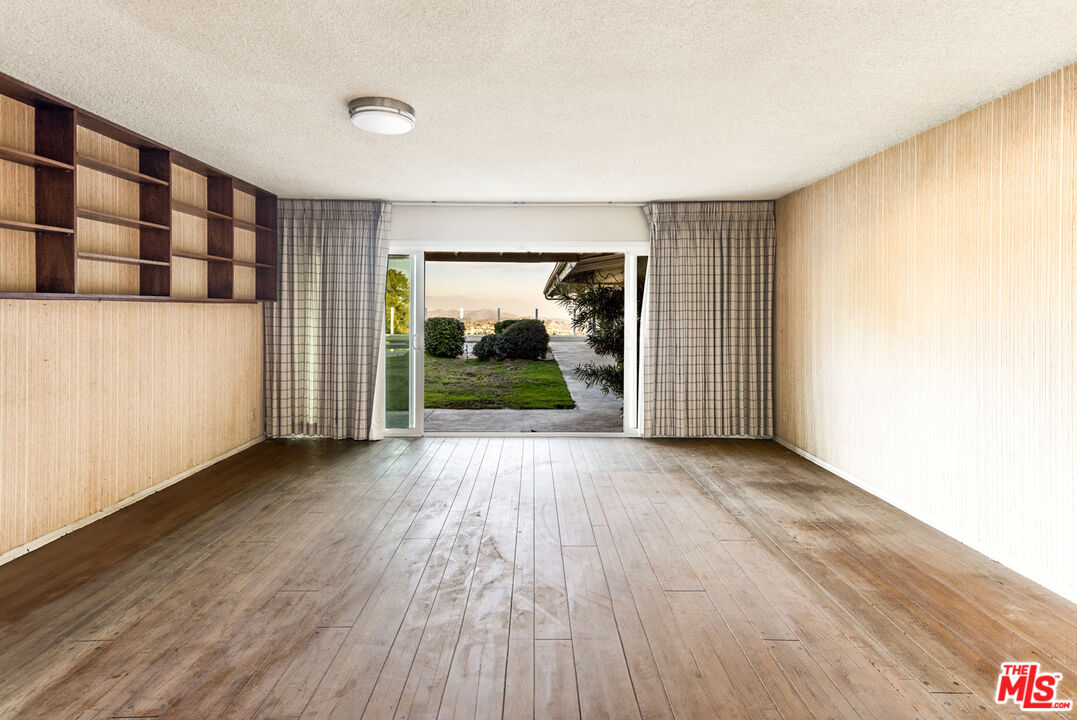 1950 Carla Ridge Beverly Hills, CA 90210 - Photo 13 of 29 wooden floor in an empty room with a window