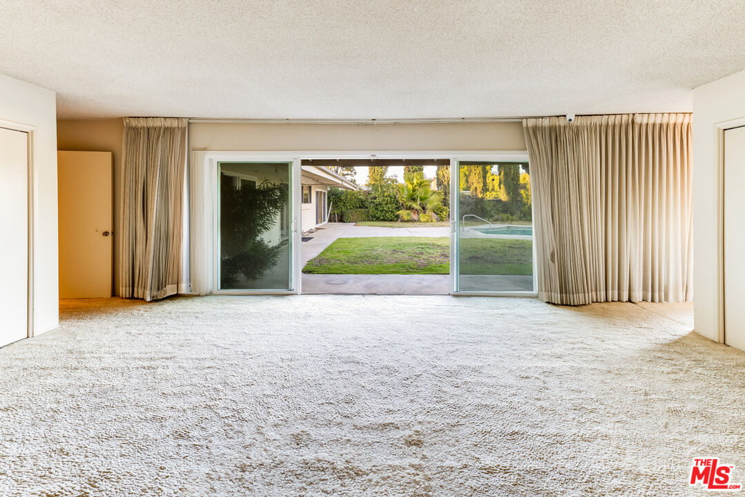 1950 Carla Ridge Beverly Hills, CA 90210 - Photo 14 of 29 an empty room with floor to ceiling windows and pool table