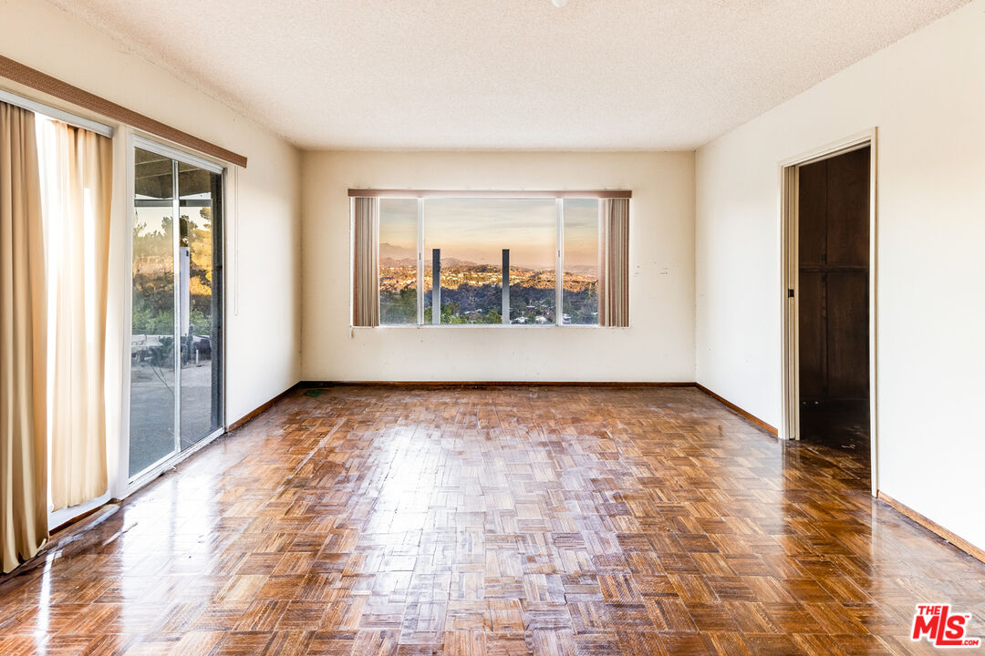 1950 Carla Ridge Beverly Hills, CA 90210 - Photo 17 of 29 a view of an empty room with a window