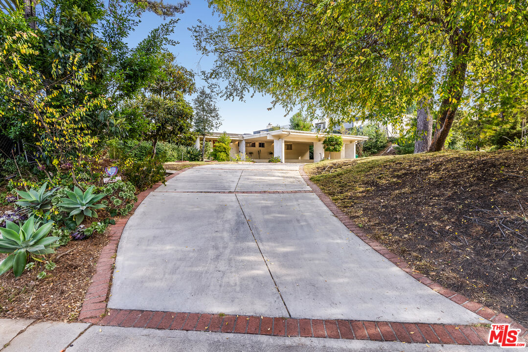 1950 Carla Ridge Beverly Hills, CA 90210 - Photo 2 of 29 a front view of a house with yard