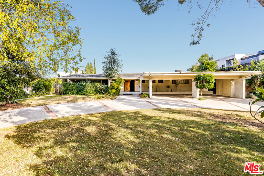 1950 Carla Ridge Beverly Hills, CA 90210 - Photo 3 of 29 a front view of a house with a yard