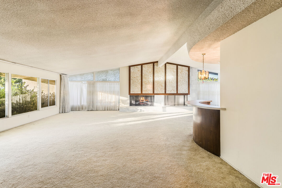 1950 Carla Ridge Beverly Hills, CA 90210 - Photo 8 of 29 a view of an empty room with a window