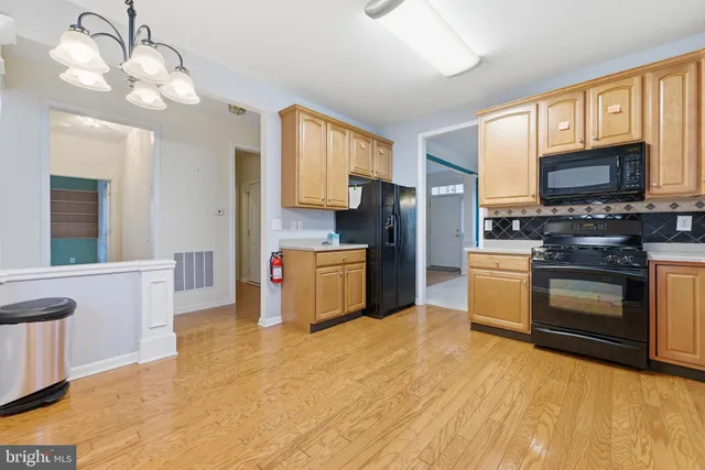 a kitchen with stainless steel appliances a stove refrigerator sink and microwave