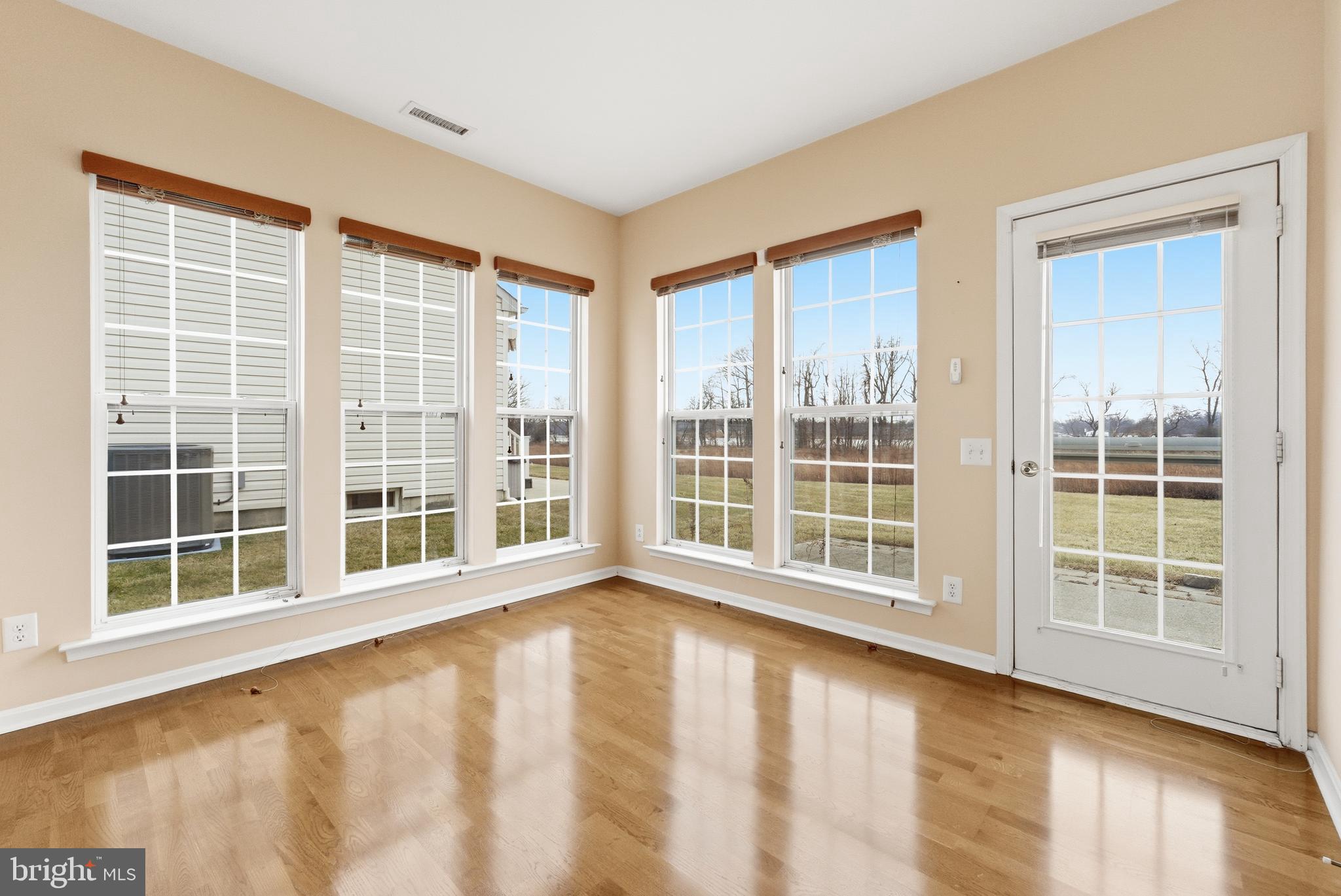 67 Pennington Court Delanco, NJ 08075 - Photo 16 of 35 a view of an empty room with a window and wooden floor