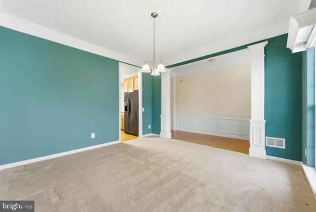 a view of a room with window and chandelier