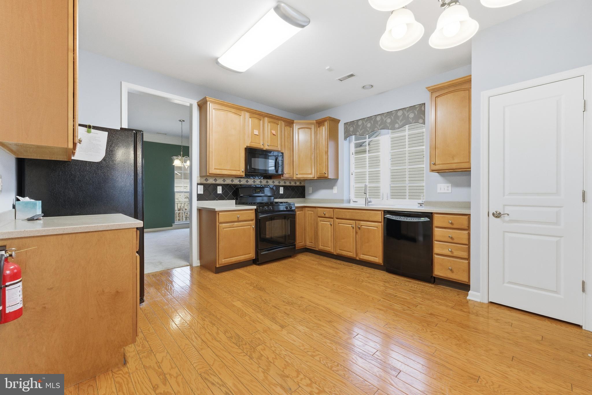 67 Pennington Court Delanco, NJ 08075 - Photo 6 of 35 a kitchen with stainless steel appliances a sink a stove a refrigerator cabinets and a window
