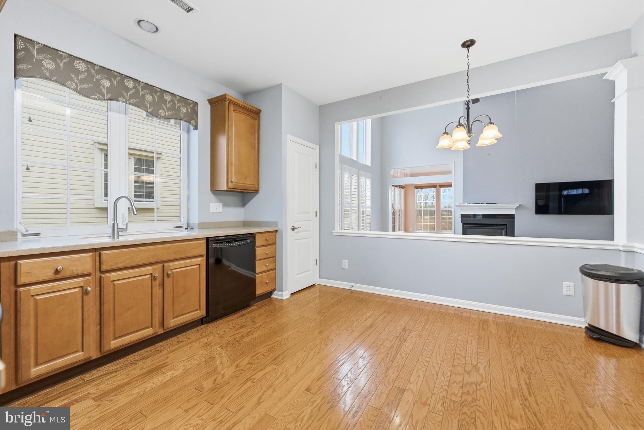 67 Pennington Court Delanco, NJ 08075 - Photo 10 of 35 a kitchen with a refrigerator a sink dishwasher a oven with white cabinets and wooden floor