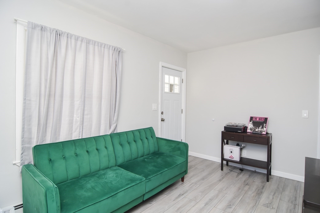 79 Turner Street Attleboro, MA 02703 - Photo 11 of 42 a living room with furniture and a wooden floor