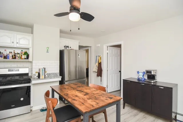 a kitchen with a table and refrigerator