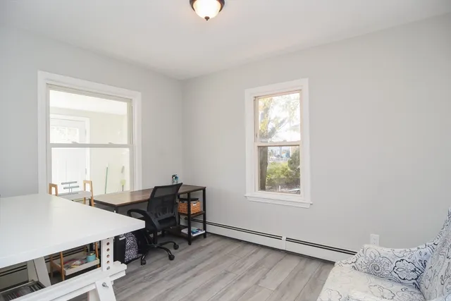 a view of a workspace with furniture and a window