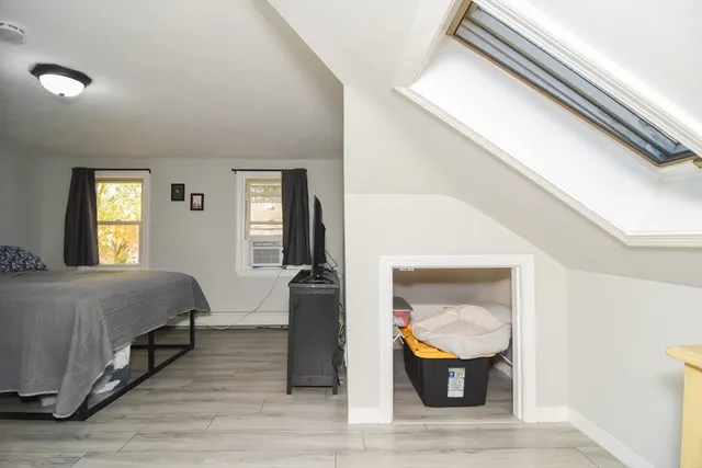 a bedroom with a bed and mirror on dresser