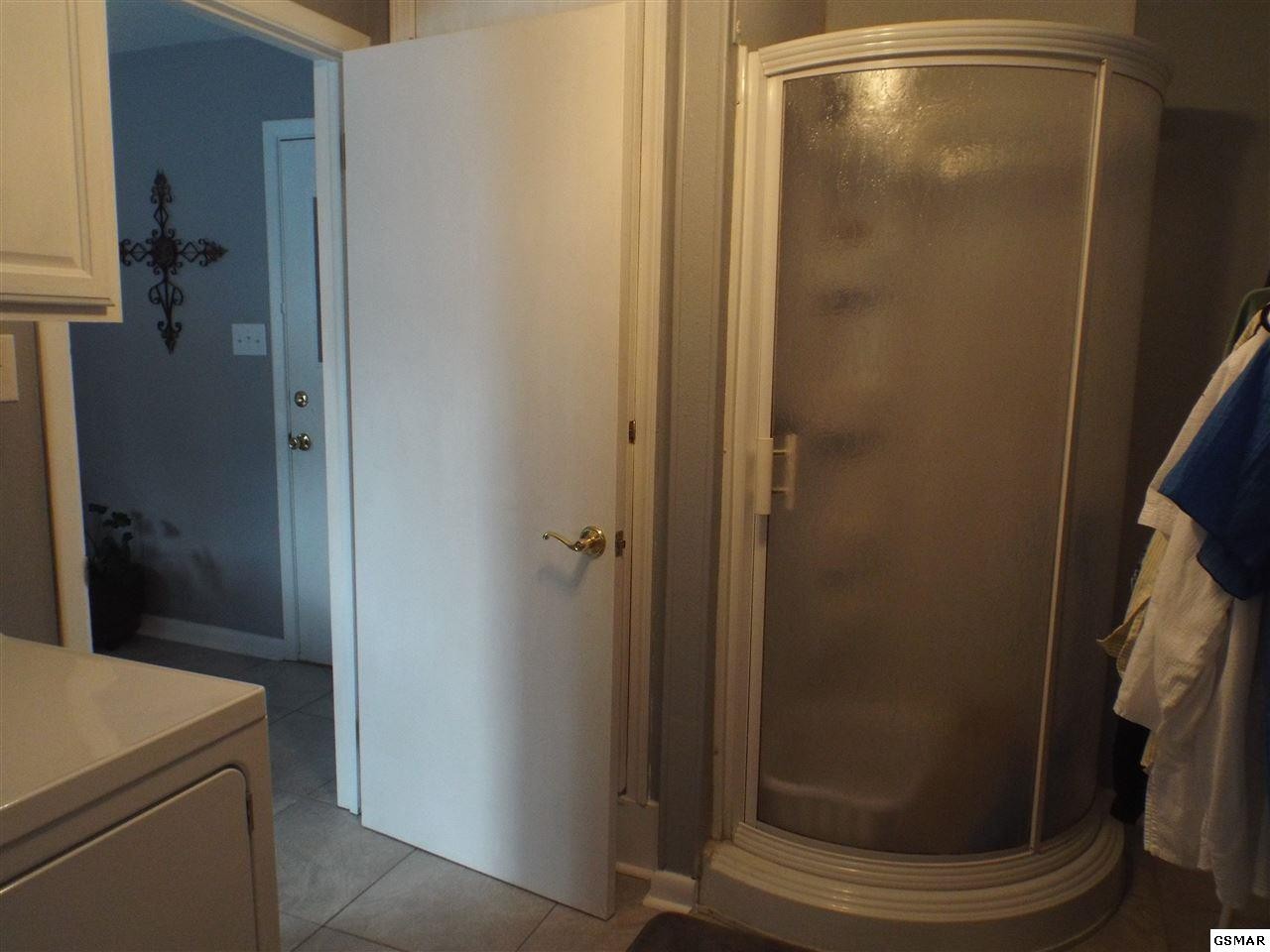 417 New Riverside Drive Sevierville, TN 37862 - Photo 10 of 18 a bathroom with a glass door shower
