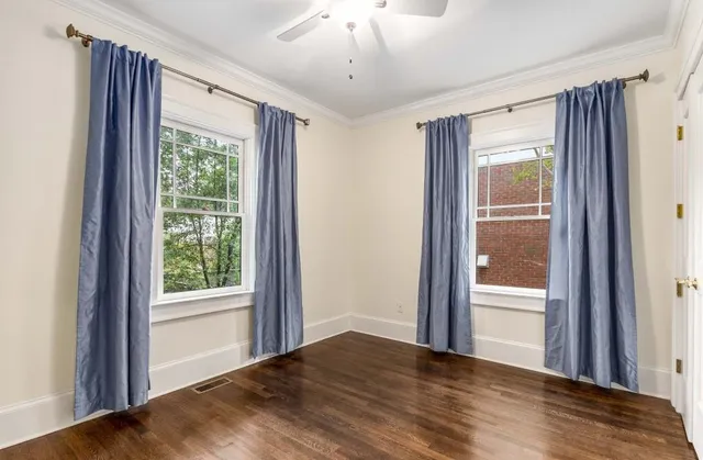 a bathroom with a toilet a sink a window and mirror