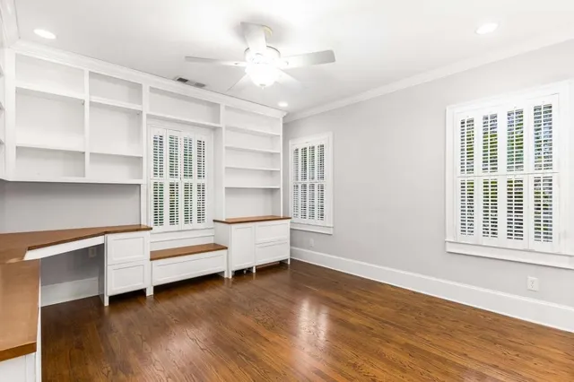 a view of walk in closet with wooden floor