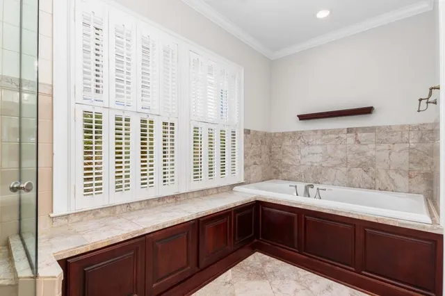 a bathroom with a granite countertop sink mirror and shower