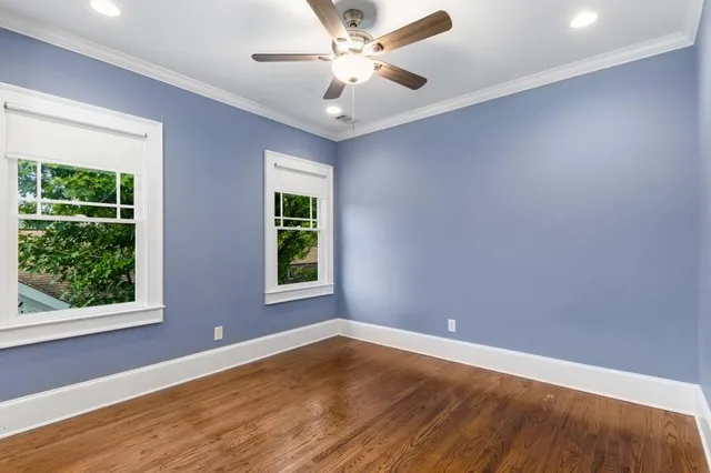 a bathroom with a granite countertop sink mirror and toilet