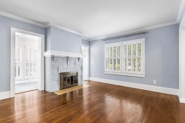 wooden floor fireplace and natural light in room