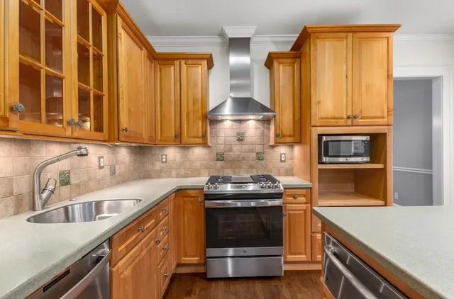 a kitchen with granite countertop a stove and a sink