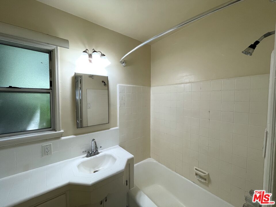 14940 Dickens Street, Unit 1 Sherman Oaks, CA 91403 - Photo 11 of 16 a bathroom with a sink toilet and shower
