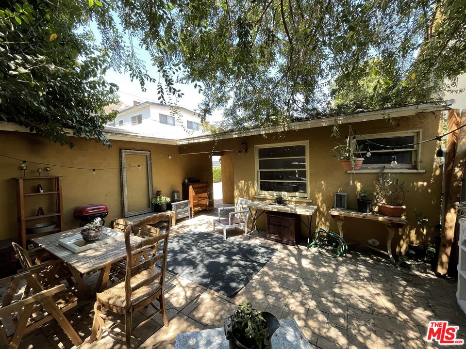 14940 Dickens Street, Unit 1 Sherman Oaks, CA 91403 - Photo 14 of 16 a view of a dinning table and chairs in the patio