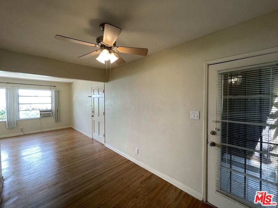 14940 Dickens Street, Unit 1 Sherman Oaks, CA 91403 - Photo 5 of 16 wooden floor in an empty room with a window