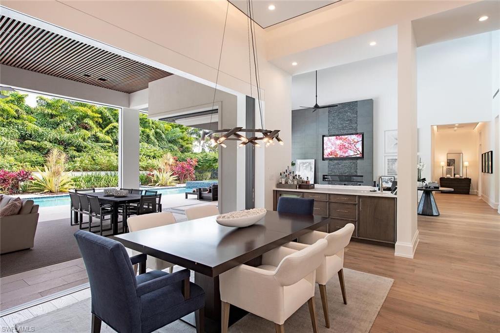 1300 Nautilus Road Naples, FL 34102 - Photo 13 of 21 a view of a dining room with furniture window and wooden floor