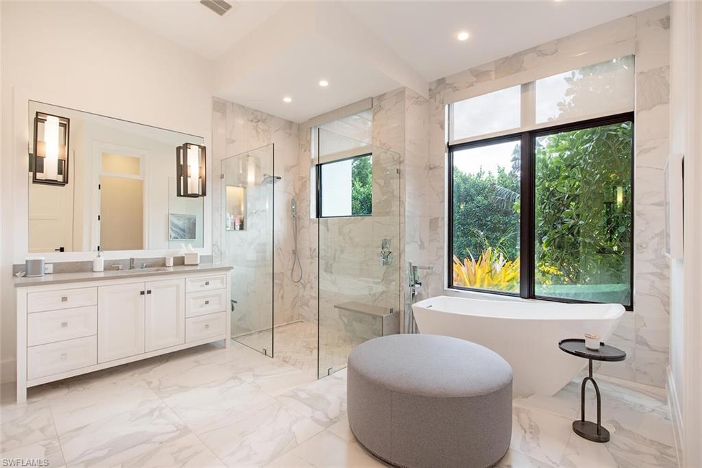 1300 Nautilus Road Naples, FL 34102 - Photo 20 of 21 a spacious bathroom with a granite countertop sink and a bathtub