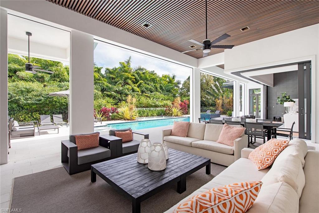 1300 Nautilus Road Naples, FL 34102 - Photo 5 of 21 a living room with patio furniture and a large window