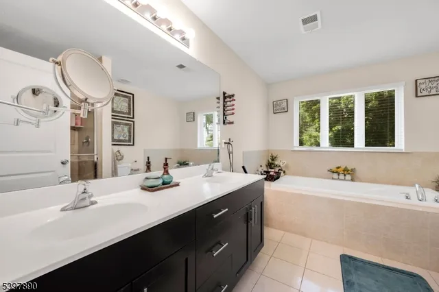a bathroom with a double vanity sink mirror and double