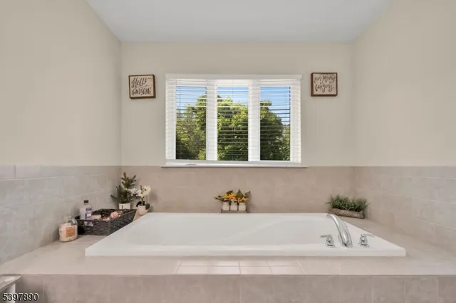 a bathroom with a bathtub and a window