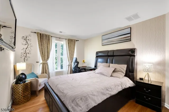 a bedroom with a bed and a night stand