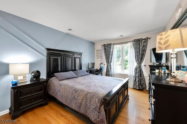 a bedroom with a bed next to a window