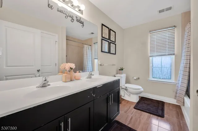 a bathroom with a sink toilet and a mirror