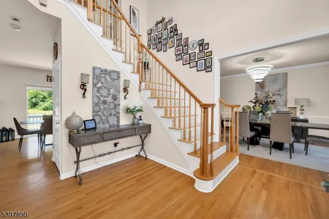 a view of entryway dining room and hall with wooden floor