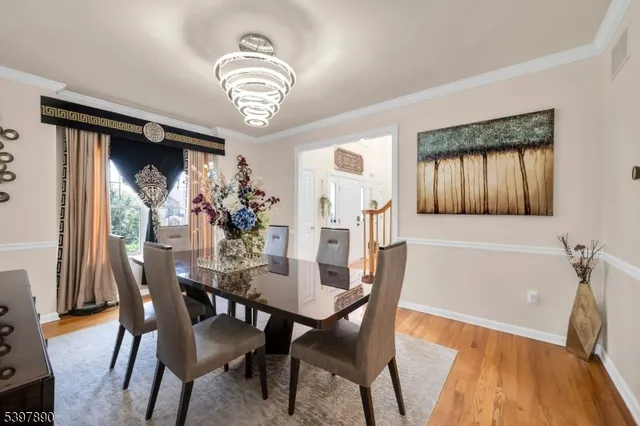 a view of a dining room with furniture and chandelier