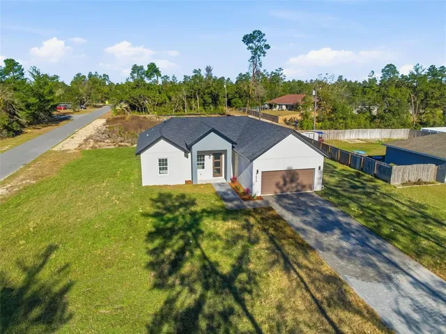 a aerial view of a house with a yard and potted plants