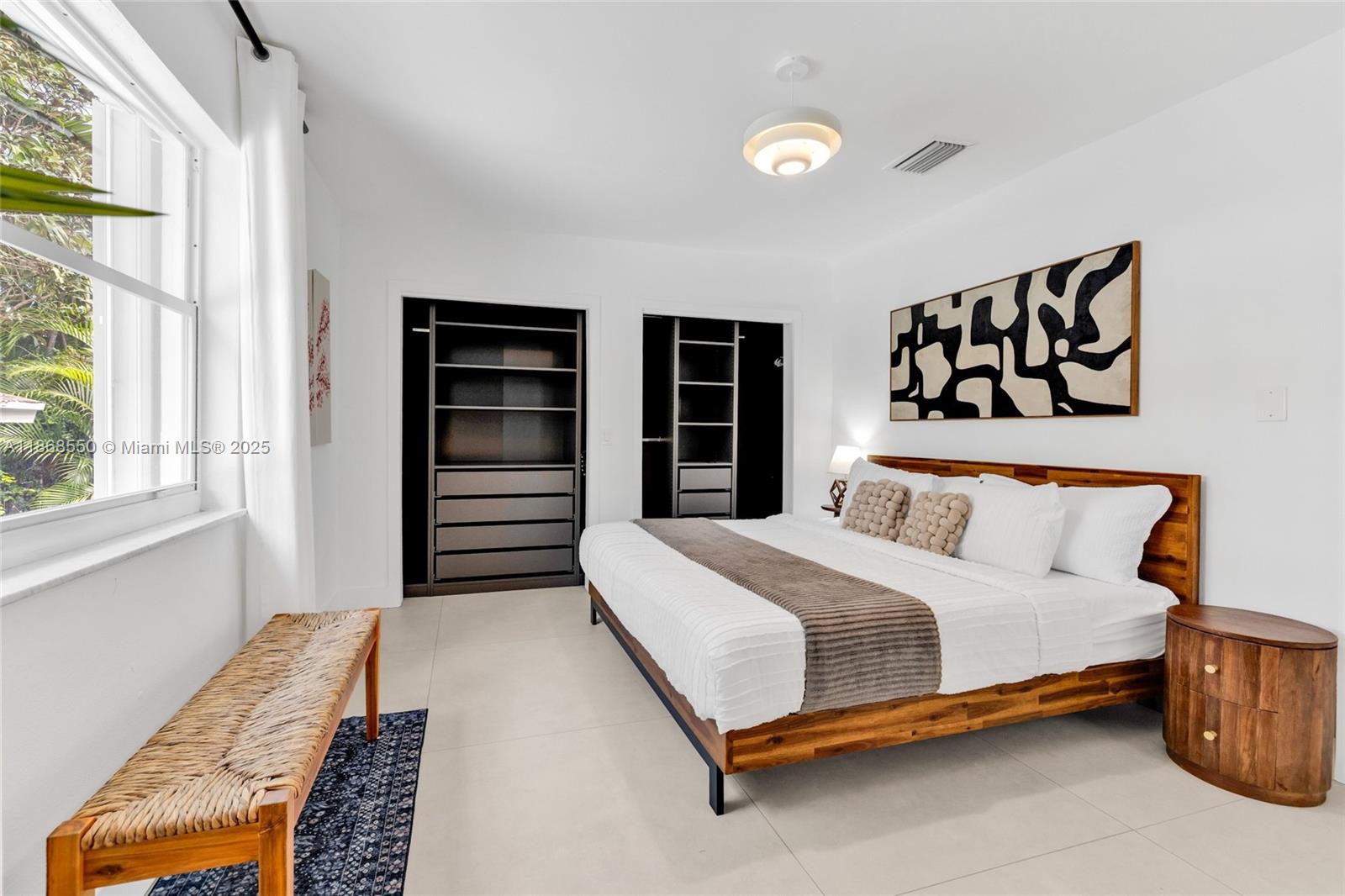 141 Southwest 23rd Road Miami, FL 33129 - Photo 11 of 32 a bedroom with a bed and a window