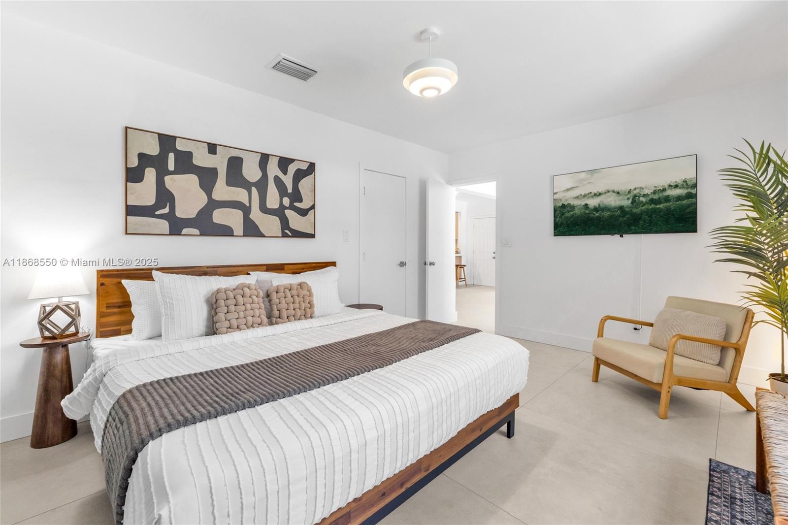 141 Southwest 23rd Road Miami, FL 33129 - Photo 12 of 32 a bedroom with a bed and a flat screen tv