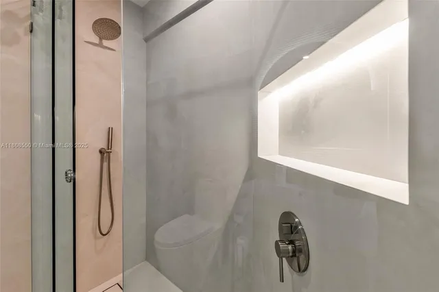 a bathroom with a glass shower door