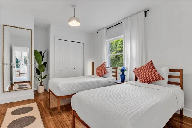 a bedroom with two beds and a dresser