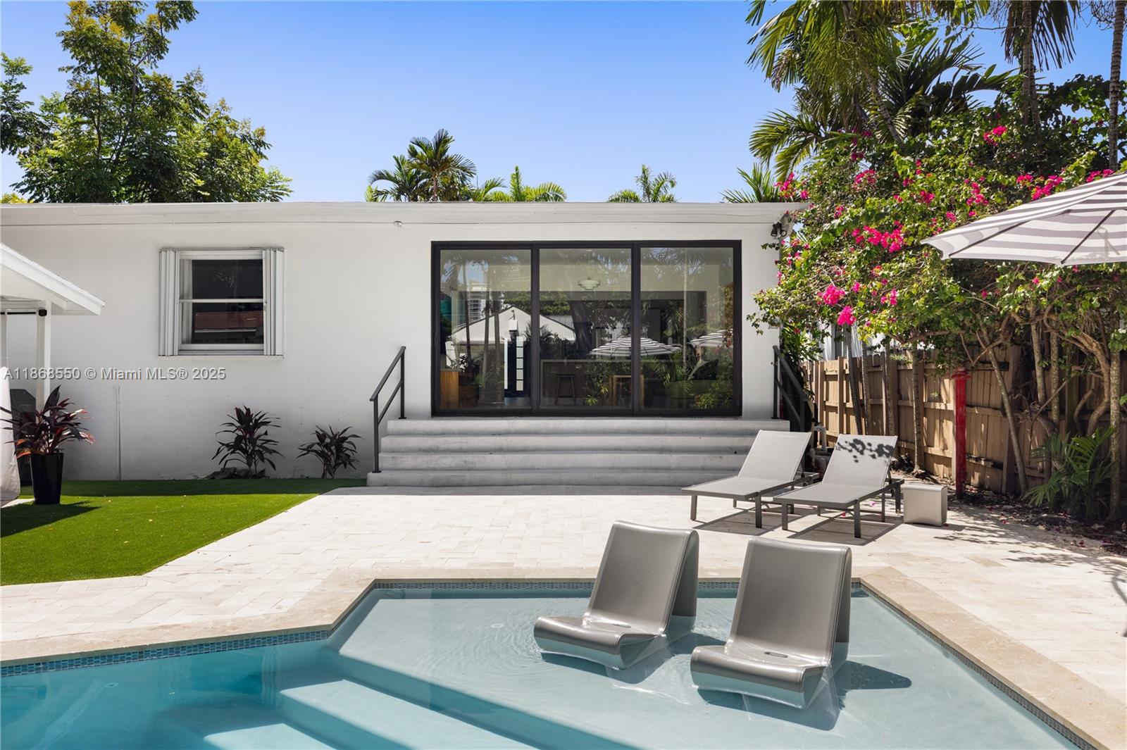 141 Southwest 23rd Road Miami, FL 33129 - Photo 25 of 32 a view of a house with backyard sitting area and garden