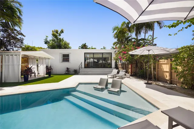 a view of a house with swimming pool and porch