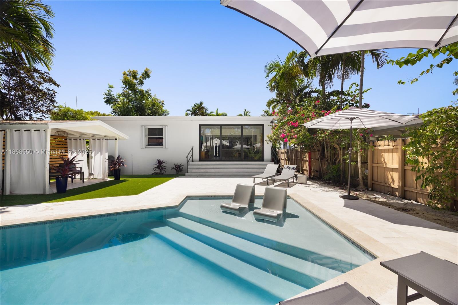 141 Southwest 23rd Road Miami, FL 33129 - Photo 26 of 32 a view of a house with swimming pool and porch