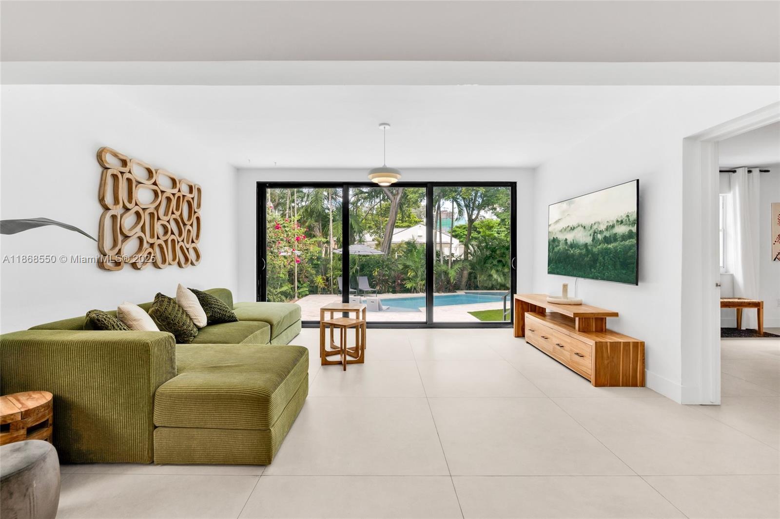 141 Southwest 23rd Road Miami, FL 33129 - Photo 3 of 32 a living room with furniture and a flat screen tv