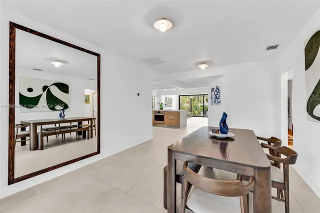 a view of a dining room with furniture and a potted plant