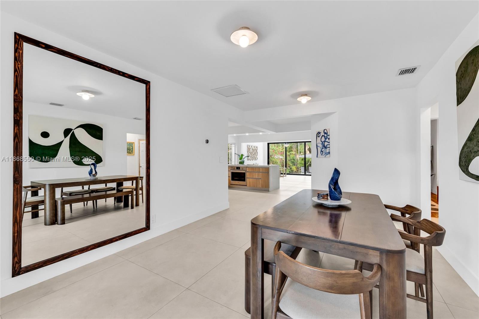 141 Southwest 23rd Road Miami, FL 33129 - Photo 10 of 32 a view of a dining room with furniture and a potted plant
