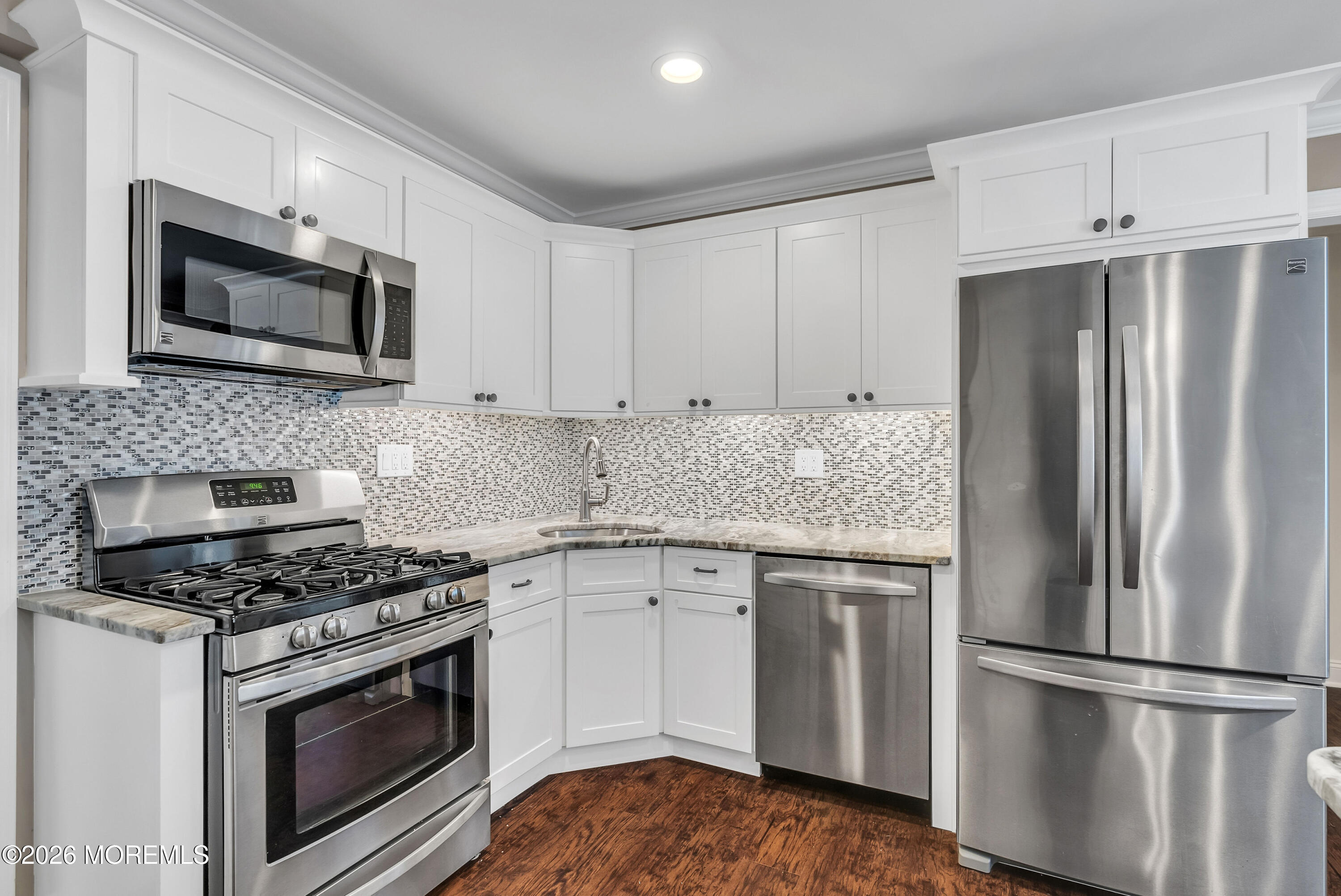 187 Pinecrest Road Oakhurst, NJ 07755 - Photo 14 of 26 a kitchen with cabinets stainless steel appliances and wooden floor
