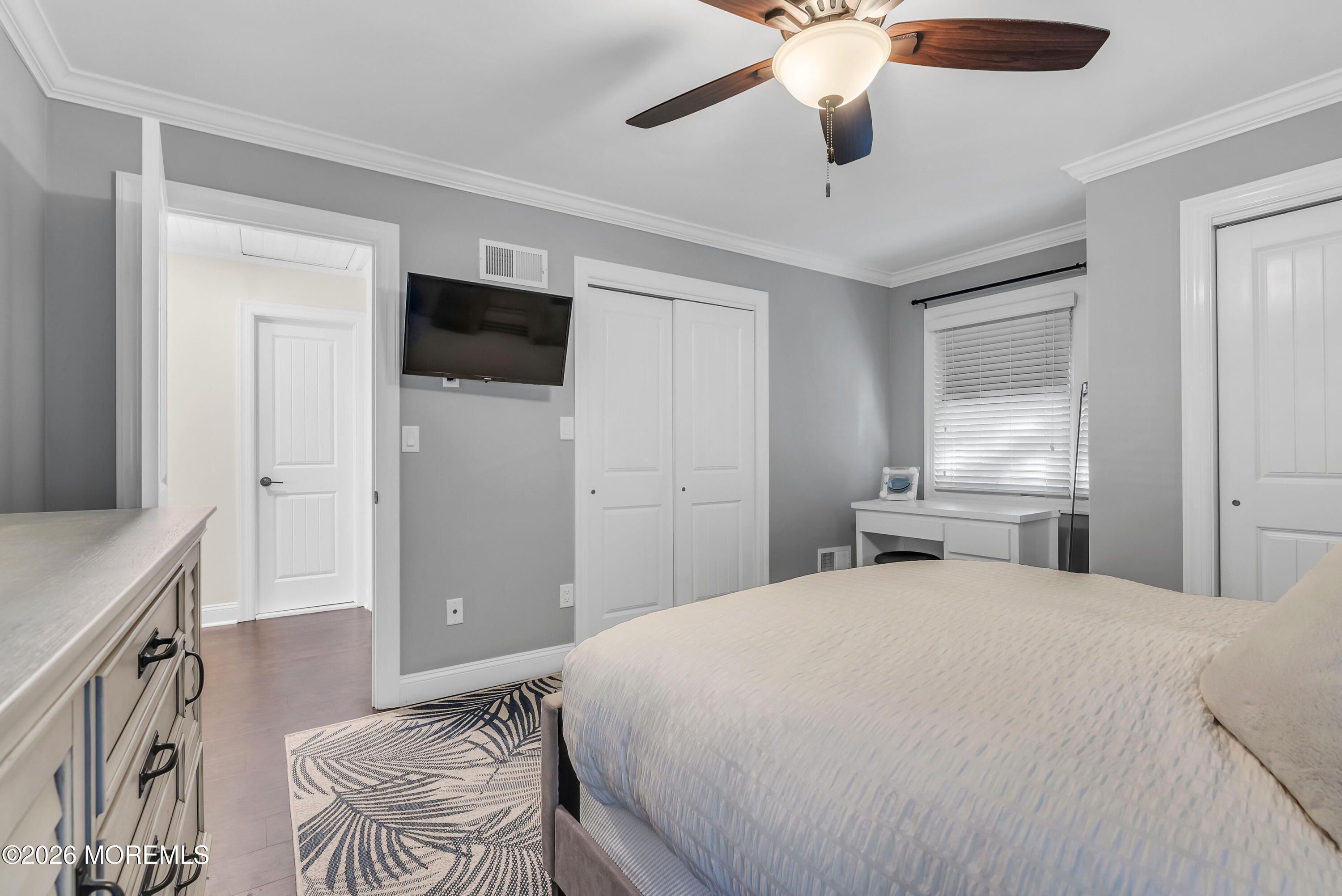 187 Pinecrest Road Oakhurst, NJ 07755 - Photo 22 of 26 a spacious bedroom with a bed and a chandelier